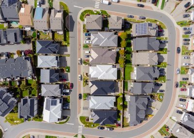 Aerial view of a modern residential development with townhomes and organized streets in Westhills.