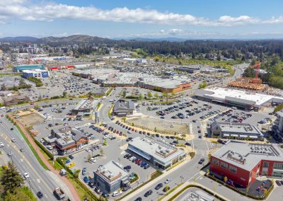 Aerial overview of Belmont Market commercial development and surrounding parking lots.