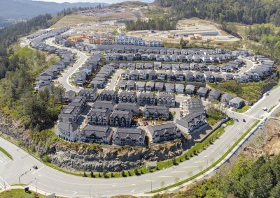 Drone photo of a large suburban neighbourhood development with homes and curved roads in Westhills.