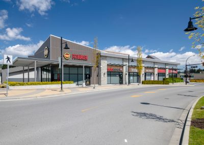 Modern retail storefronts and commercial units at Belmont Market shopping area.