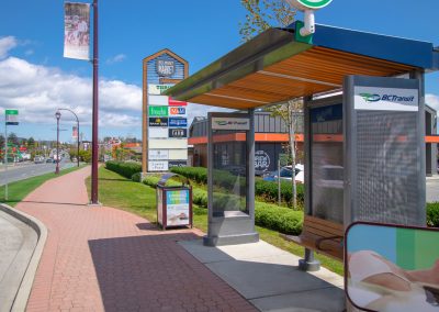 Modern BC Transit bus stop shelter with accessibility features and urban landscaping.