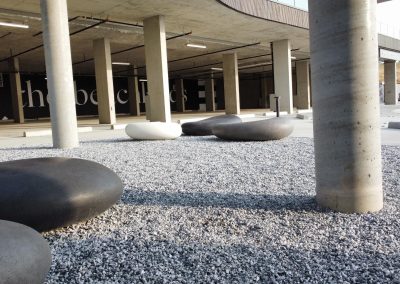 Modern outdoor seating and landscaped amenity area within the Beachlands development.