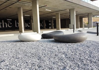 Modern outdoor seating and landscaped amenity area within the Beachlands development.
